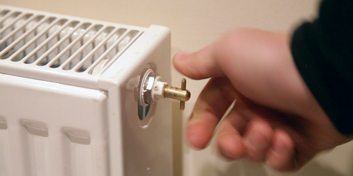 radiator bleeding with key to keep your home warm