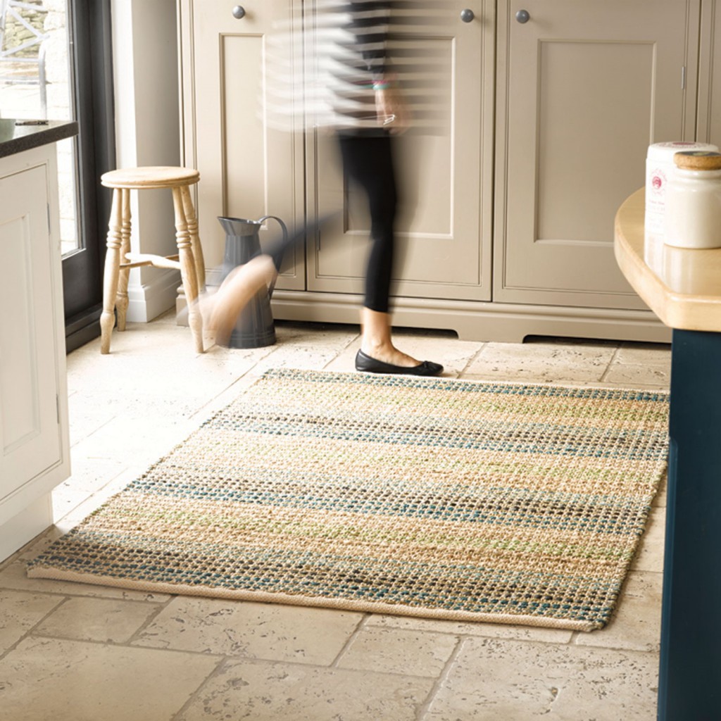 Eco-friendly rug with neutral tones sits on a slate floor in a country kitchen
