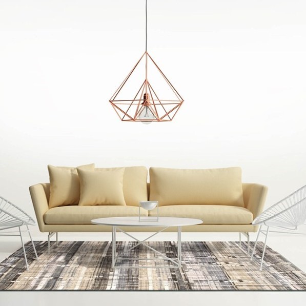 Copper interiors cage lampshade over a yellow sofa and copper thread rug in a white minimalist room