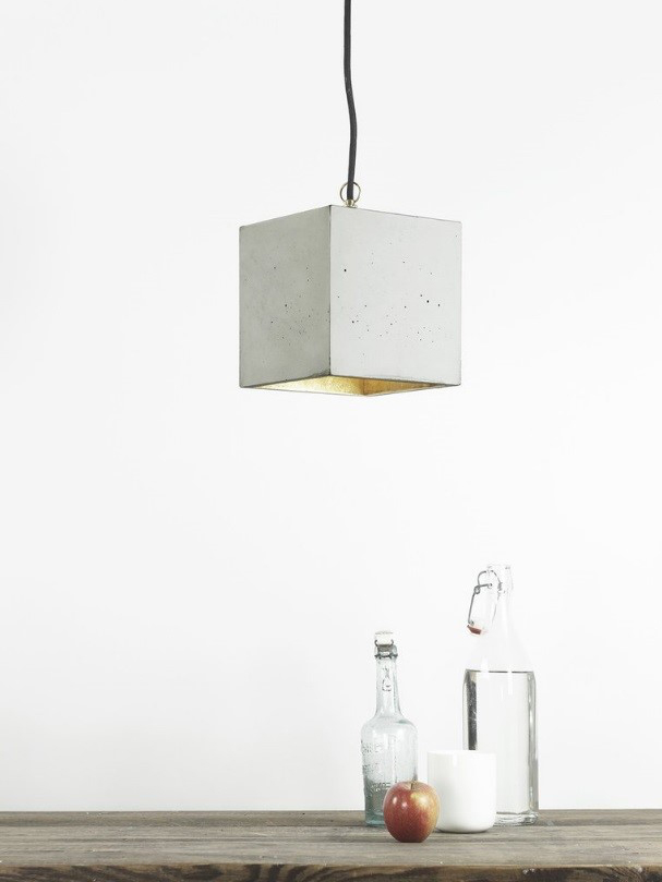 plain white wall with a concrete lamp hanging from the ceiling