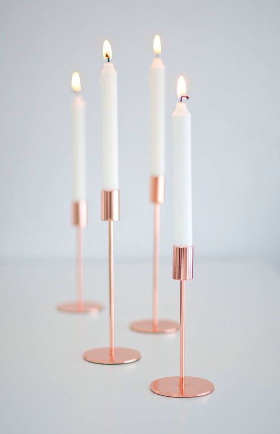 long white candles in copper candle holders for copper interiors