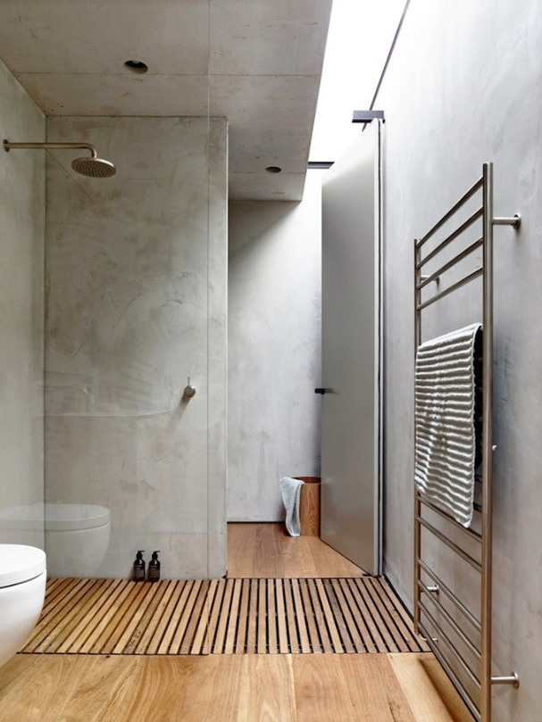stylish bathroom with a wooden floor and concrete walls