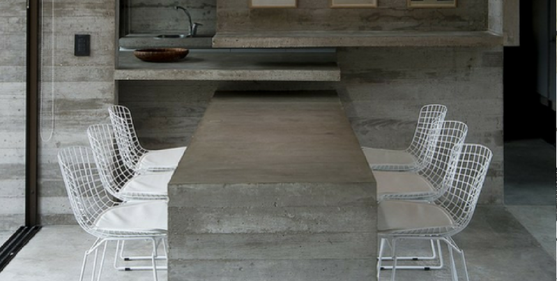 concrete furniture a concrete dining table surrounded by six white chairs