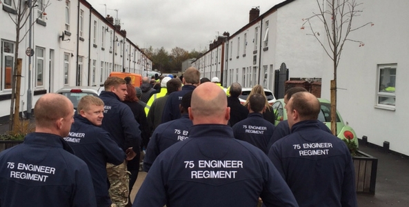 DIY SOS builders and army veterans walking towards the canada street home before reveal