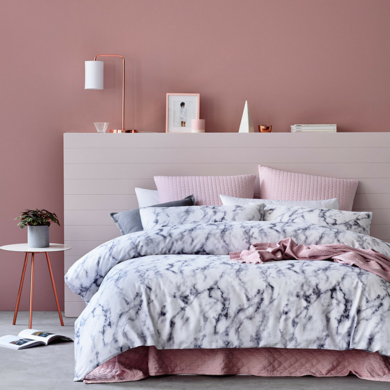 blush pink bedroom with marble and silk sheets