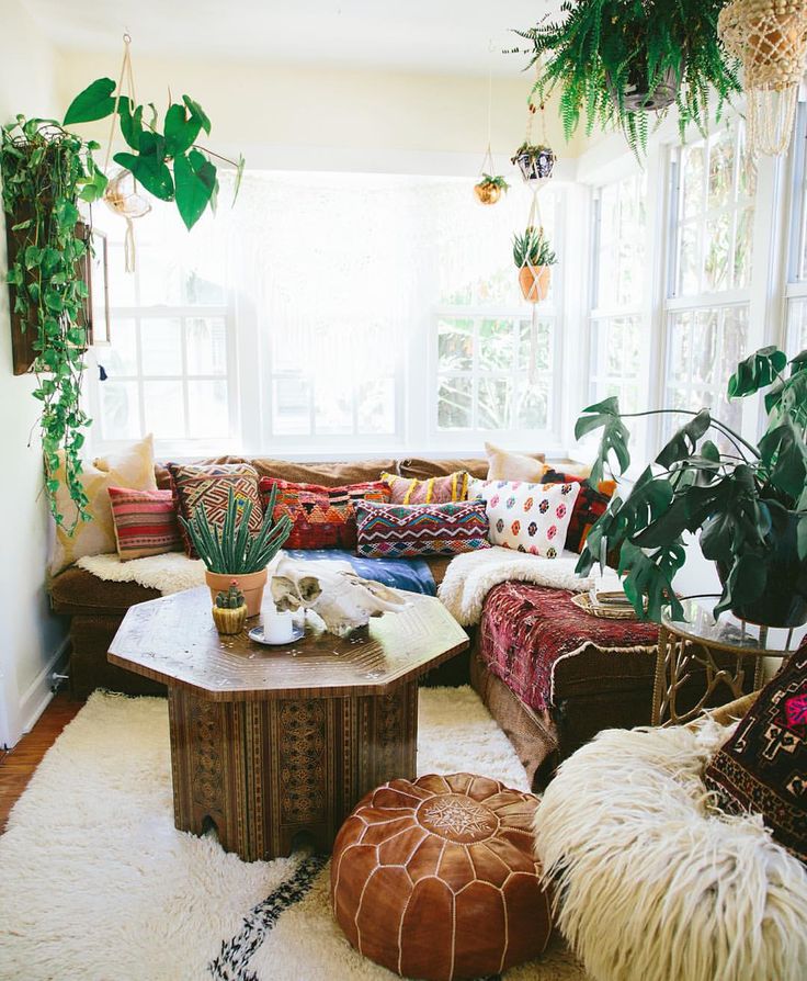 bohemian living room with a large plant and bohemian furniture accents