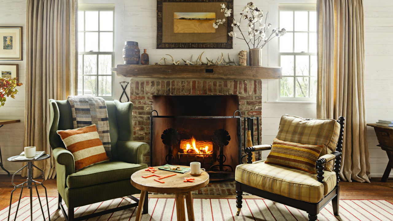 autumn cosy interior with a fireplace and sofas
