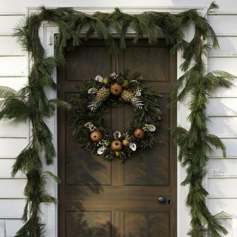 Christmas Door Wreath Decoration on a brown door with a garland