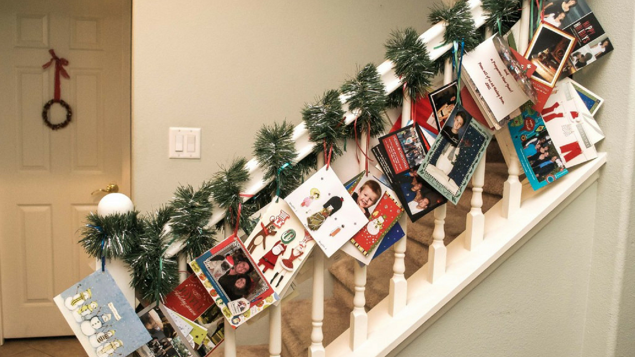 hanging christmas cards on a stairwell
