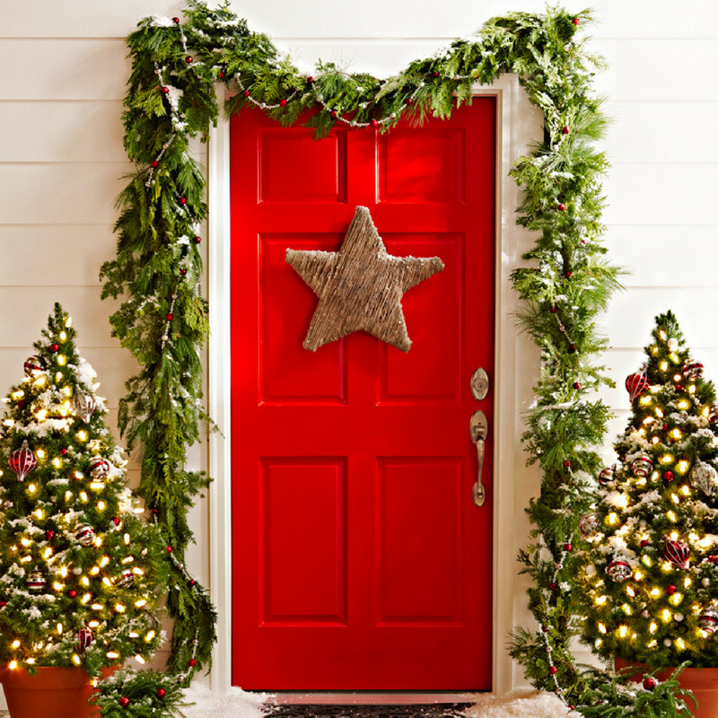 Christmas Door Star Decoration on a red door with a garland