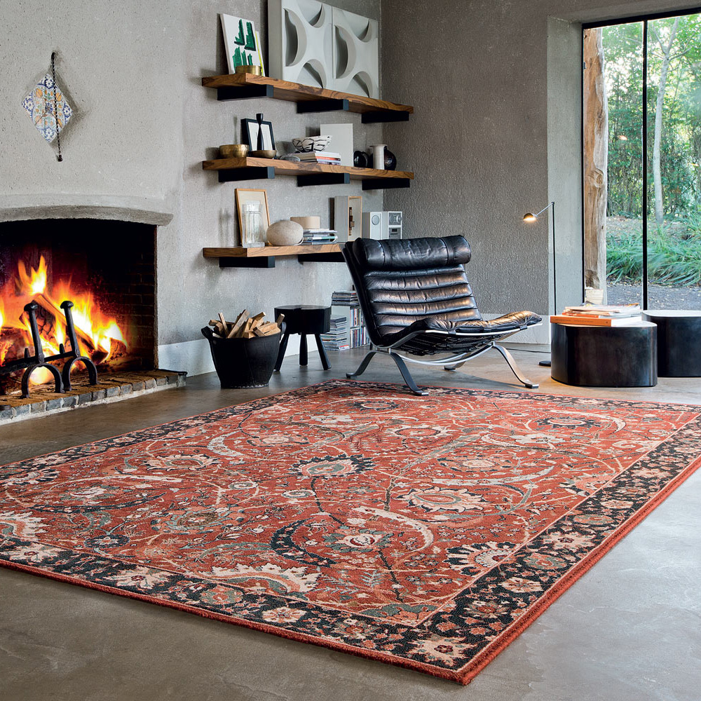 traditional rug in concrete style living room next to a chair and a roaring fireplace