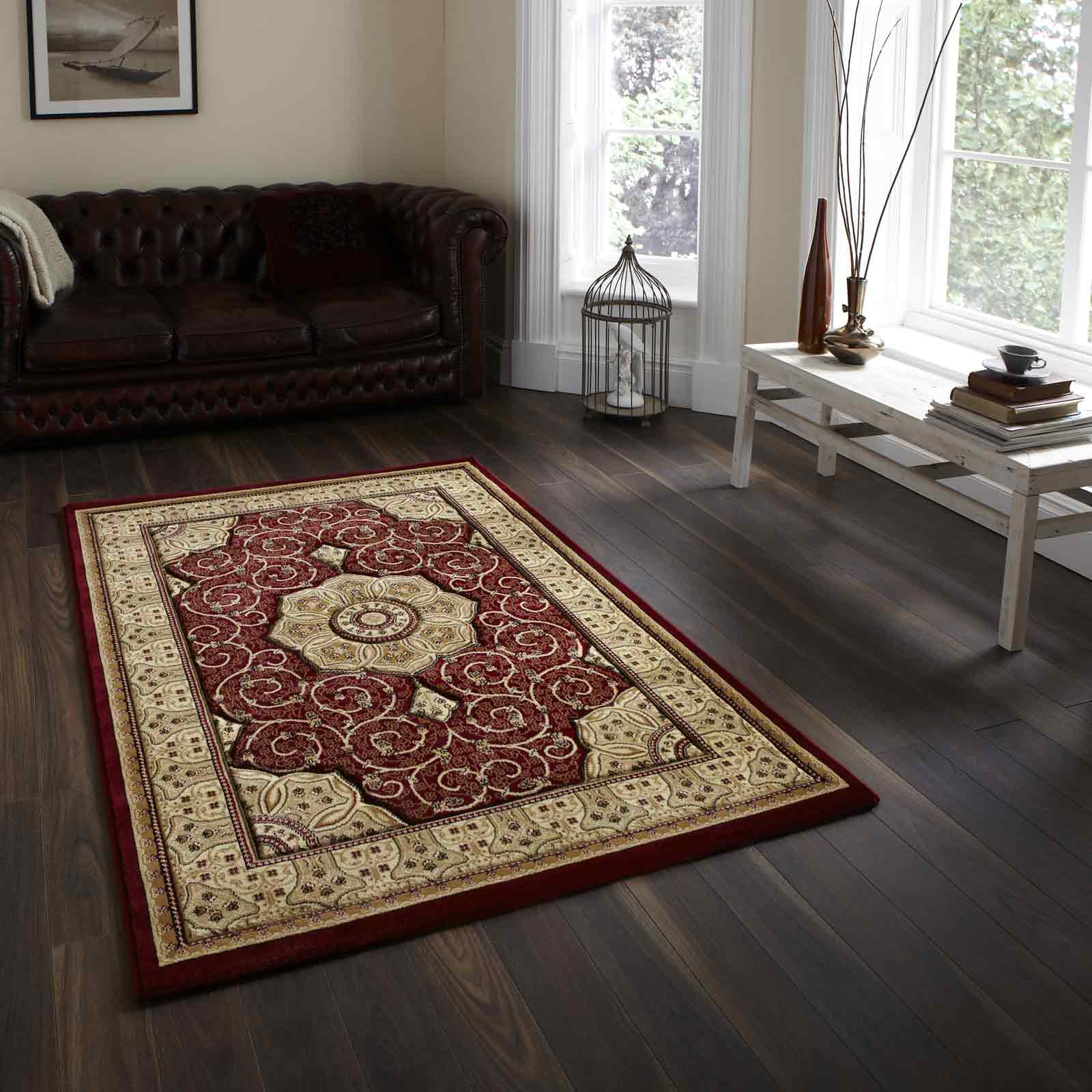 red and gold kilim rug on dark wood floor in lving room with a leather couch