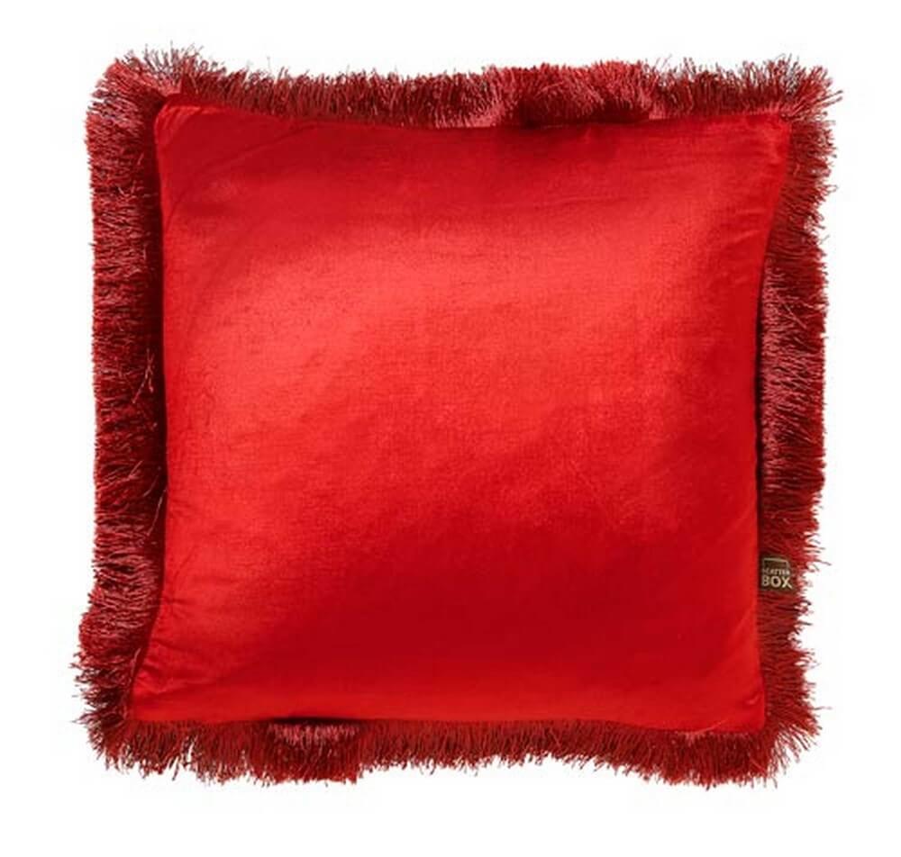 a red fringed cushion