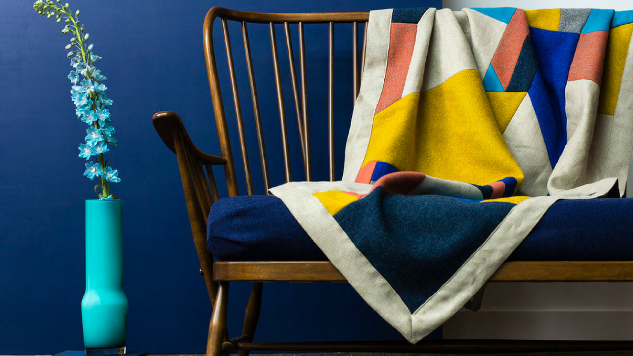 Colourful Decor Throw Blanket Over A Blue Sofa