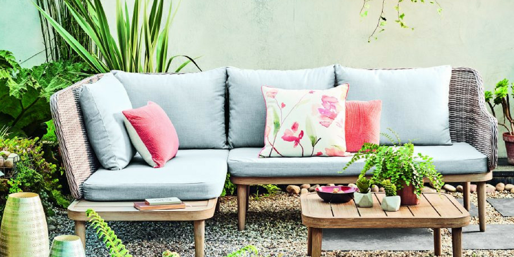 Outdoor Space with Greenery and Stylish Floral Cushions