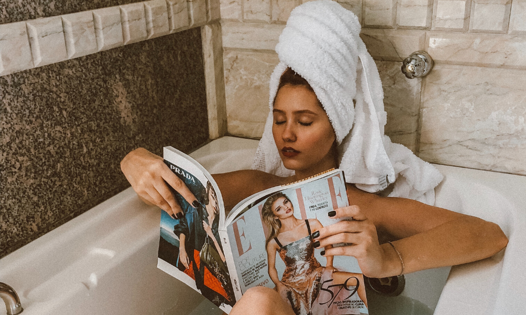 Eco-Friendly Home - Lady in Bath reading a magazine