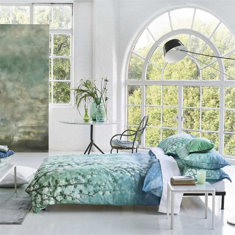 blue indian blossom bedding in white bedroom with natural light and windows