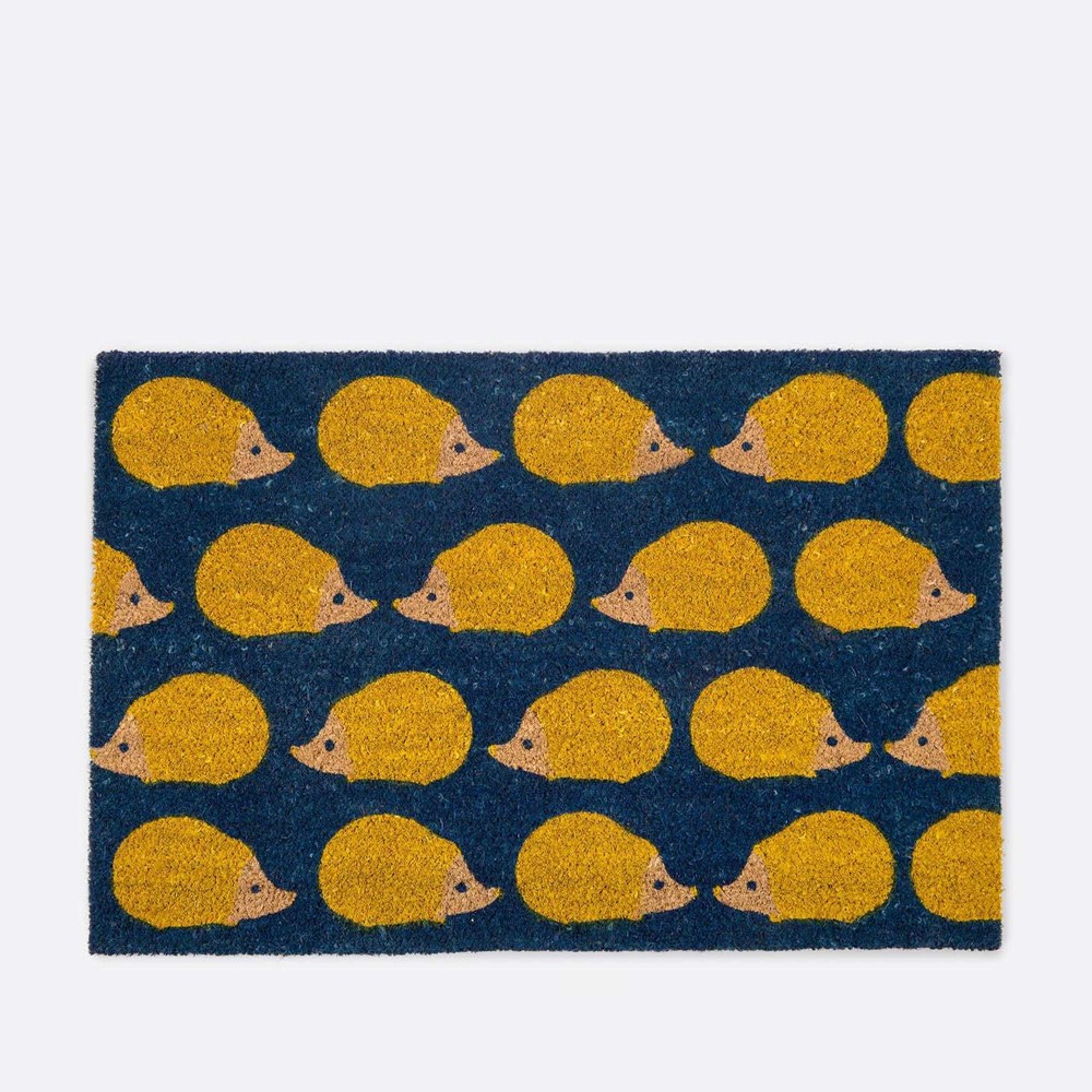 yellow hedgehog print on a navy background of a doormat 
