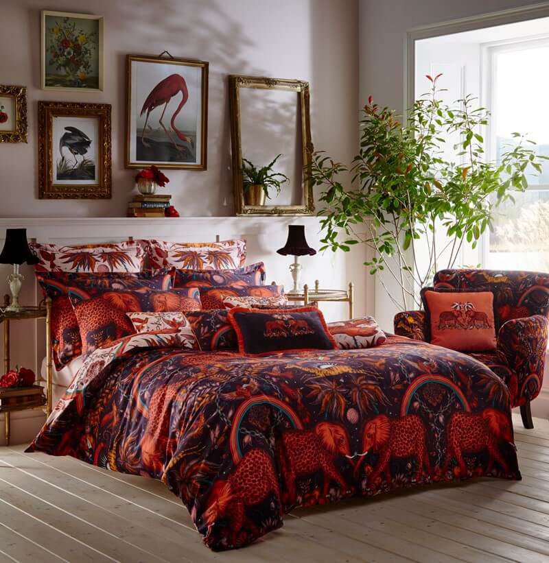 luxury bedding set in a burgundy zembezi elephant print in a modern bedroom