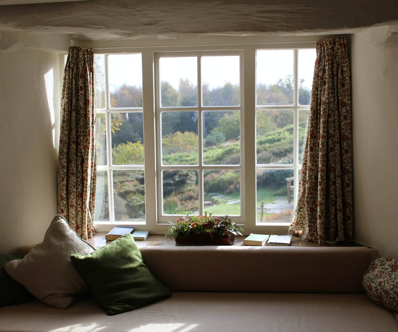 a small windowsill being used as seating within a cottage