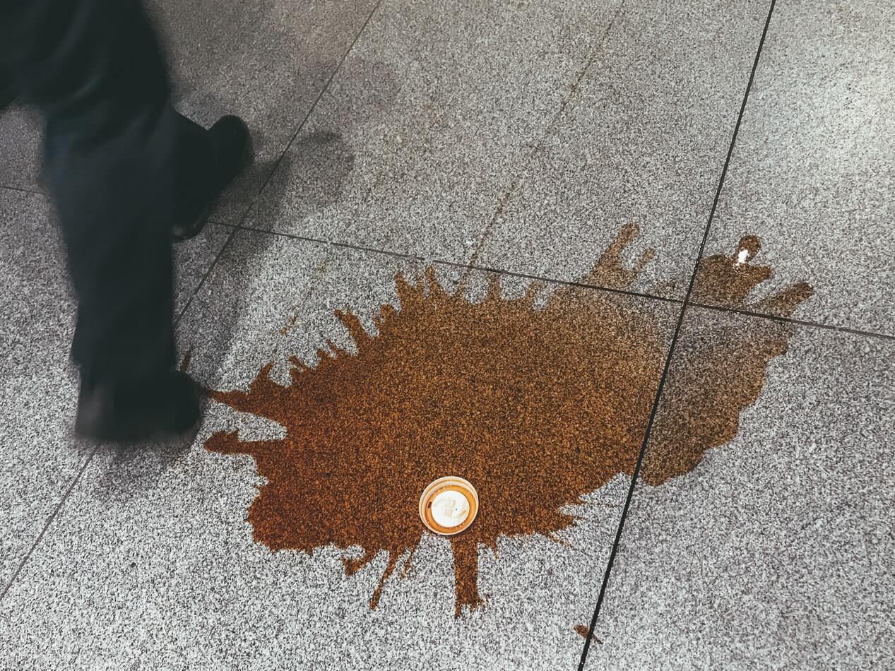 coffee spilt on a tiled floor