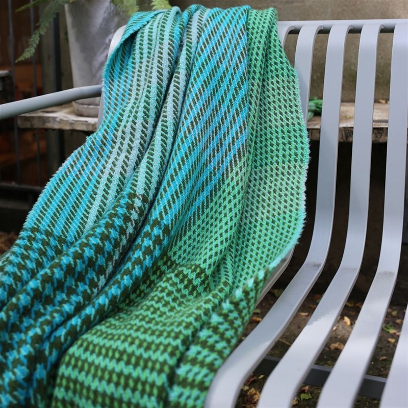 the arket green and blue dogtooth patterned throw draped on a chair as a gift for him