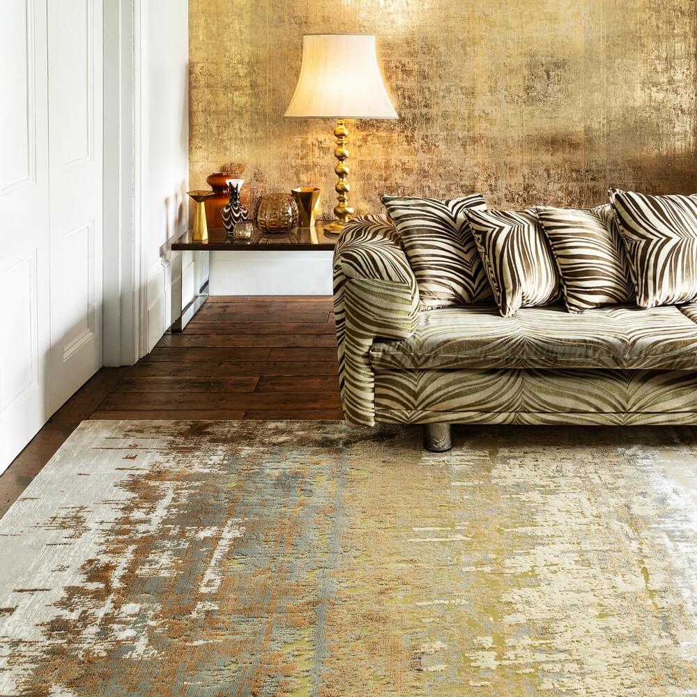 the aurora dune rug in a living room with a sofa sat on the edge of it showing hot you make your rug last