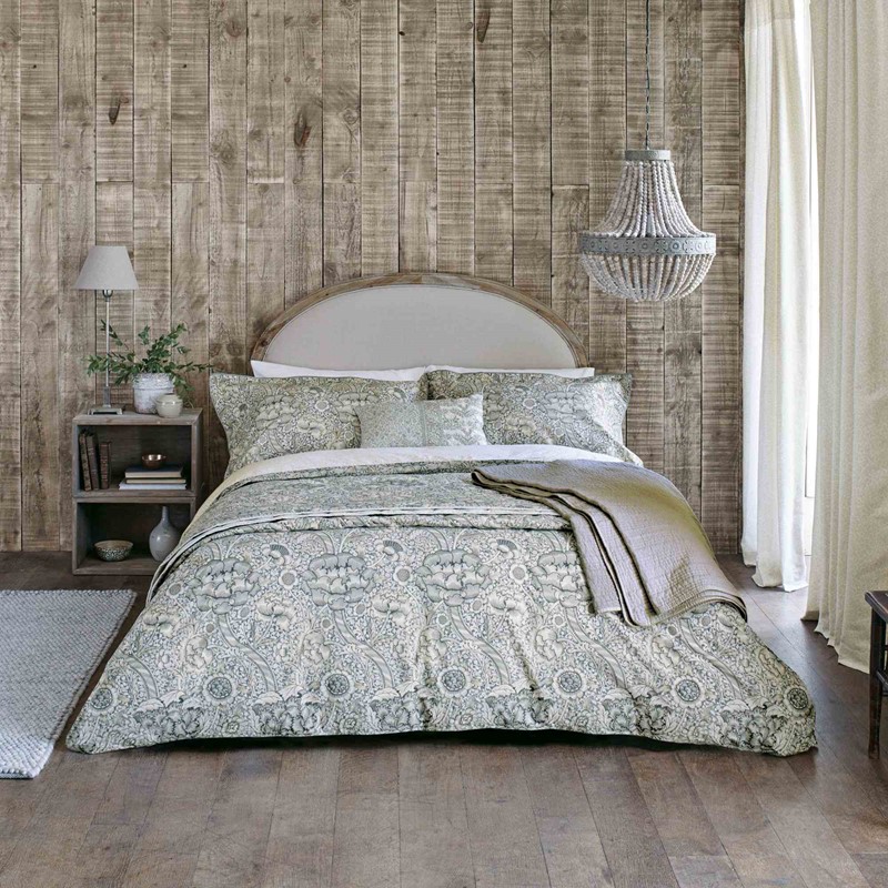 the wandle bedding set in muted colours on a bed in a wooden and modern bedroom design
