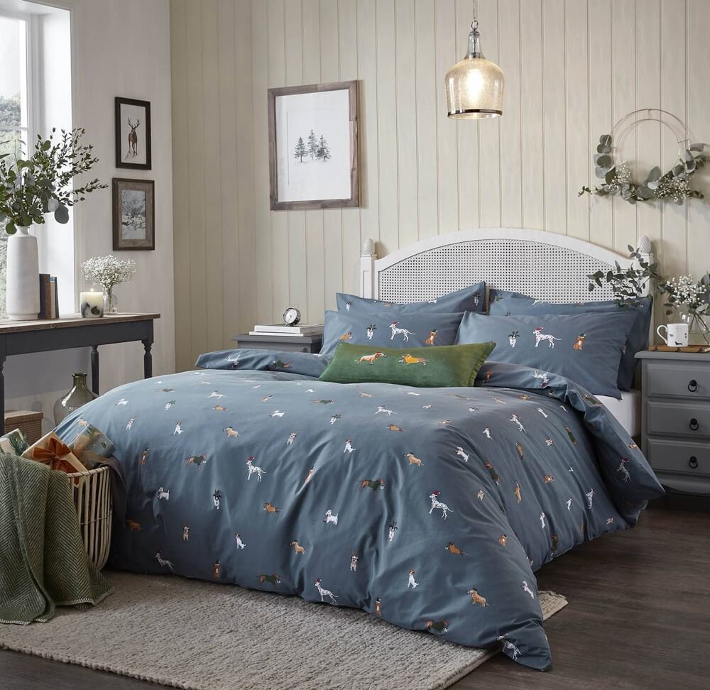 an image of a bedroom with a christmas themed bedding set with small dog illustrations for a black friday gift