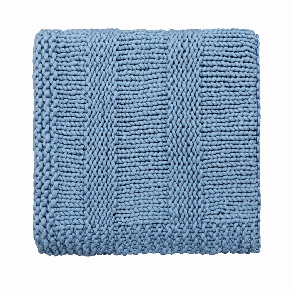 a chunky blue knit blanket for the luxury new year's eve accessory
