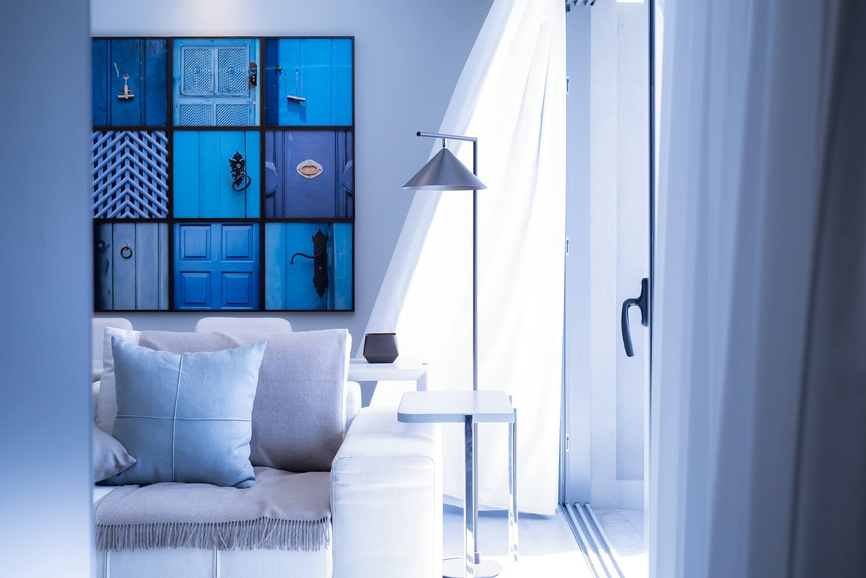 a blue room for interior trends for 2022 with blue bedding and paintings