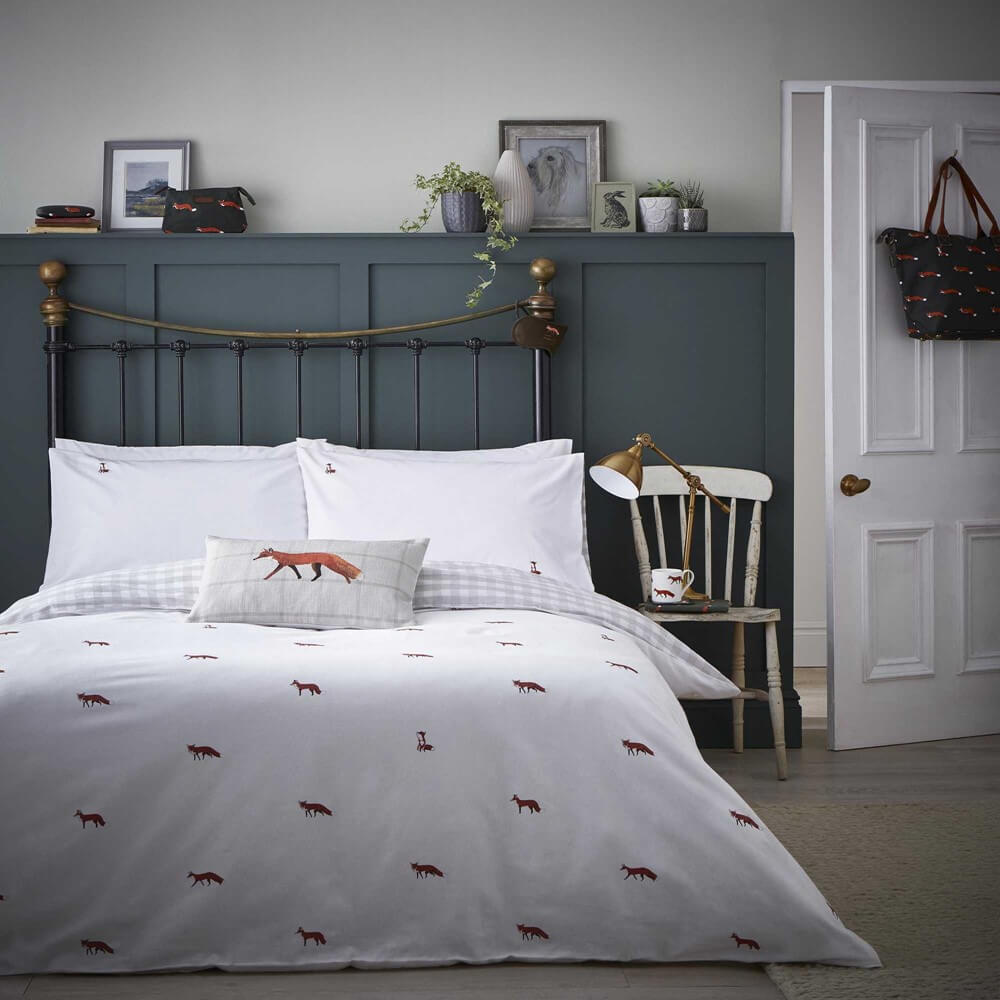 a luxurious bedding set in white with fox prints is in a minimal and cosy bedroom