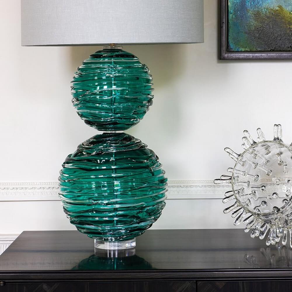 Crystal base statement lamp in turquoise blue on a table