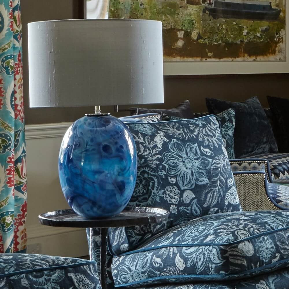 a blue crystal statement lamp on a table in a front room