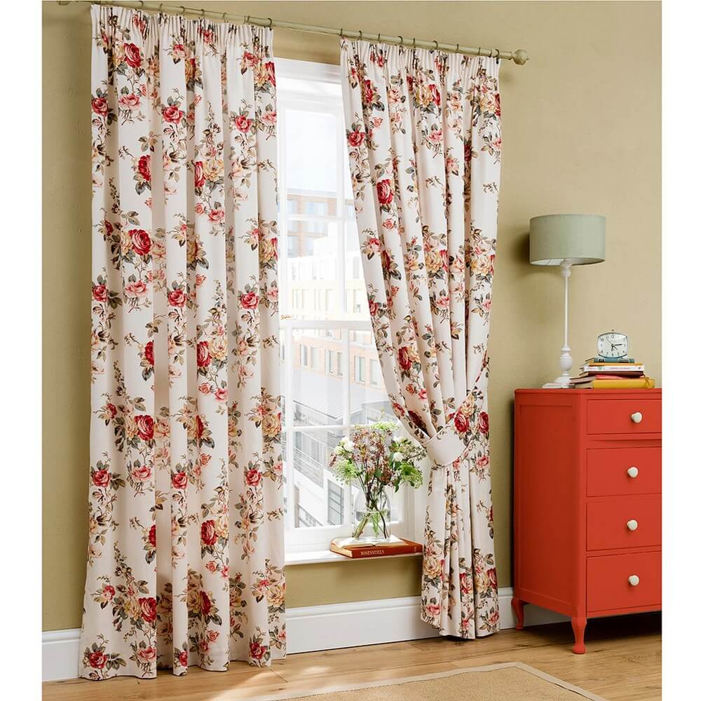 a brightly lit window with cath kidston floral curtains in a front room