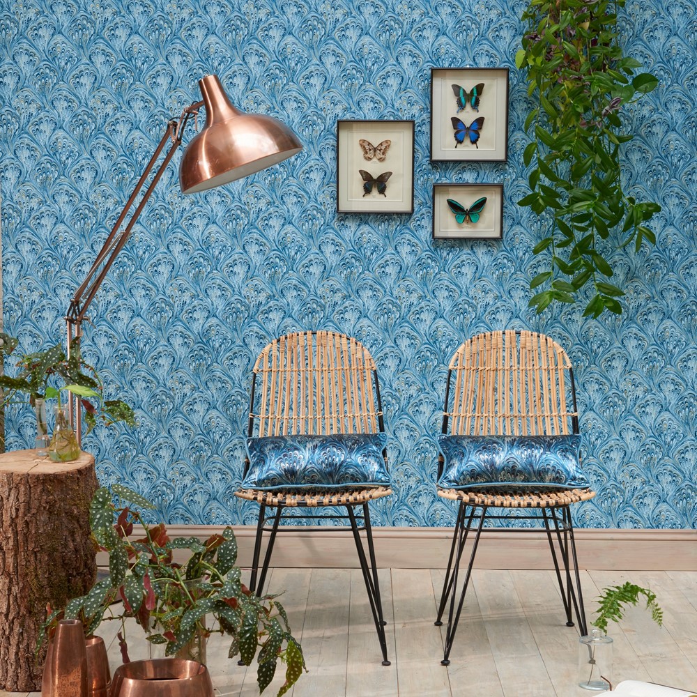 a blue pavone wallpaper in a livjng room showing how to hang wallpaper