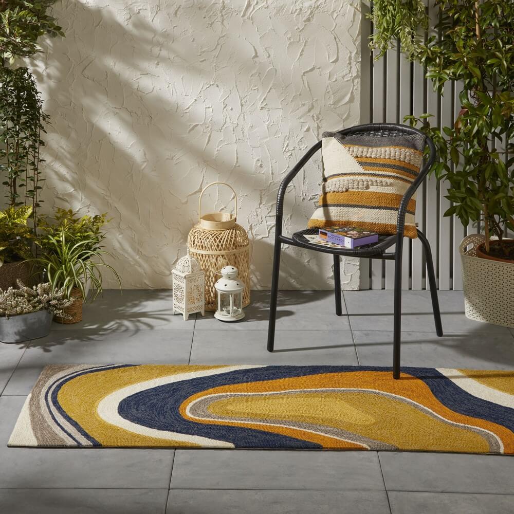 colourful aura runner is placed on a decking outdoors with a chair
