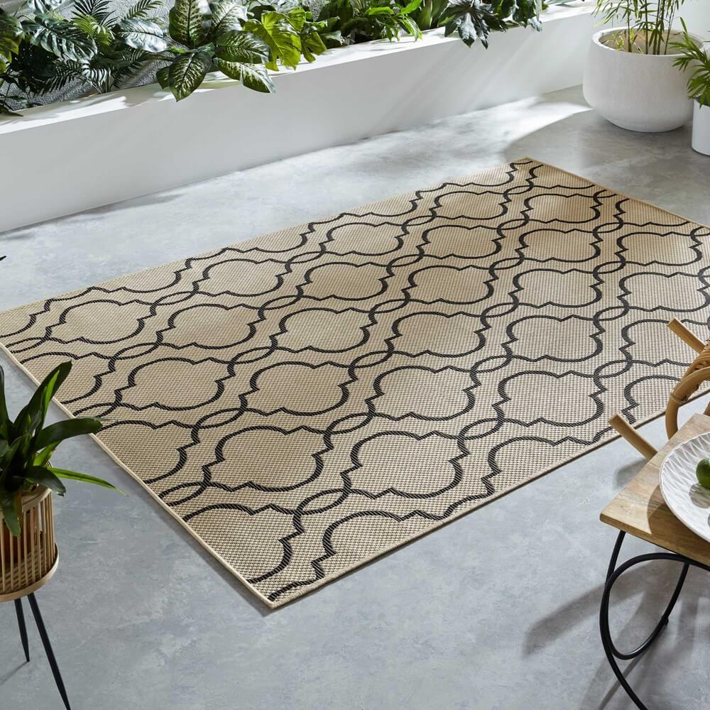 chevron diamond patterened rug is sat on an outdoor decking