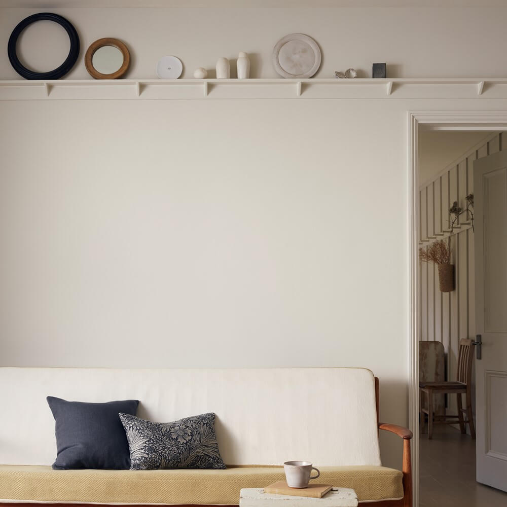 A cream coloured wall in a living space to show the best colour to paint your bedroom