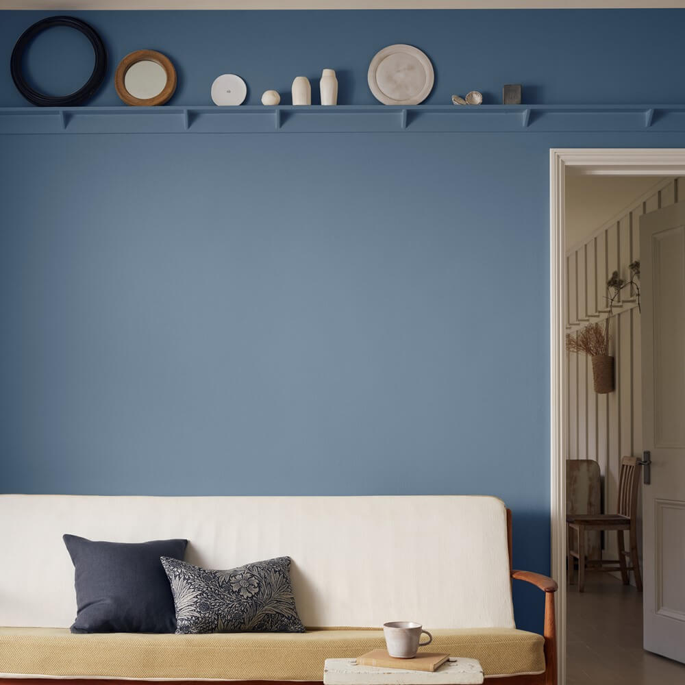A sea blue painted wall in a living room space