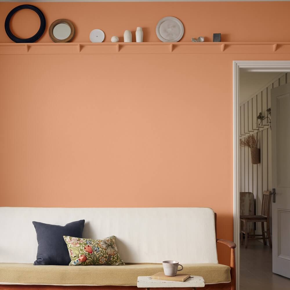 a light orange painted wall in a living room space