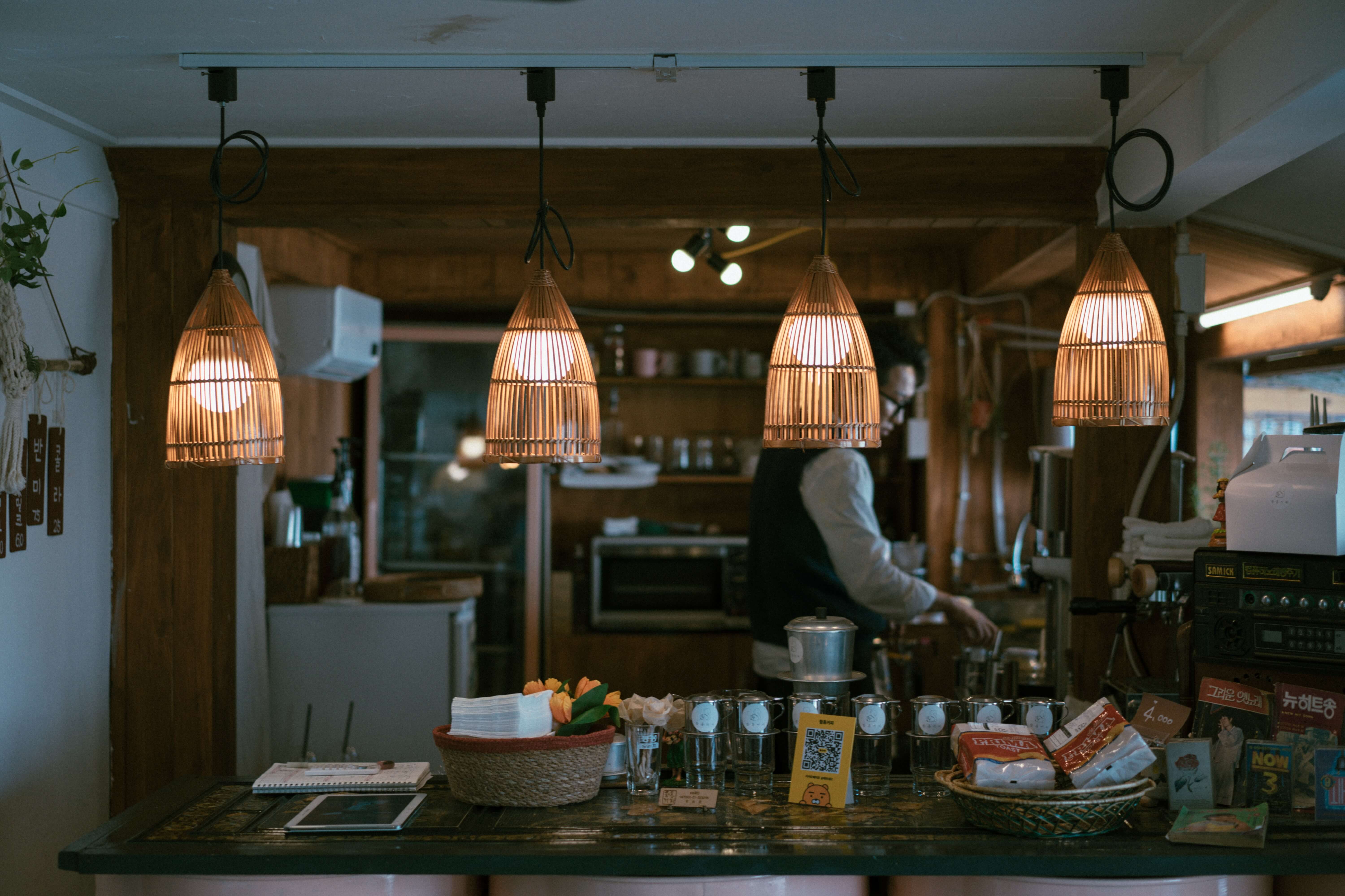 Low hanging lights in kitchen interiors over a wooden table