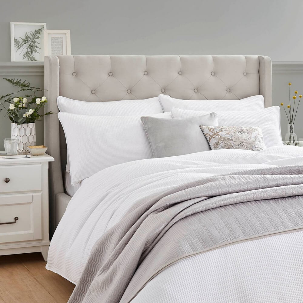 White laura ashley waffle bedding in a minimal bedroom