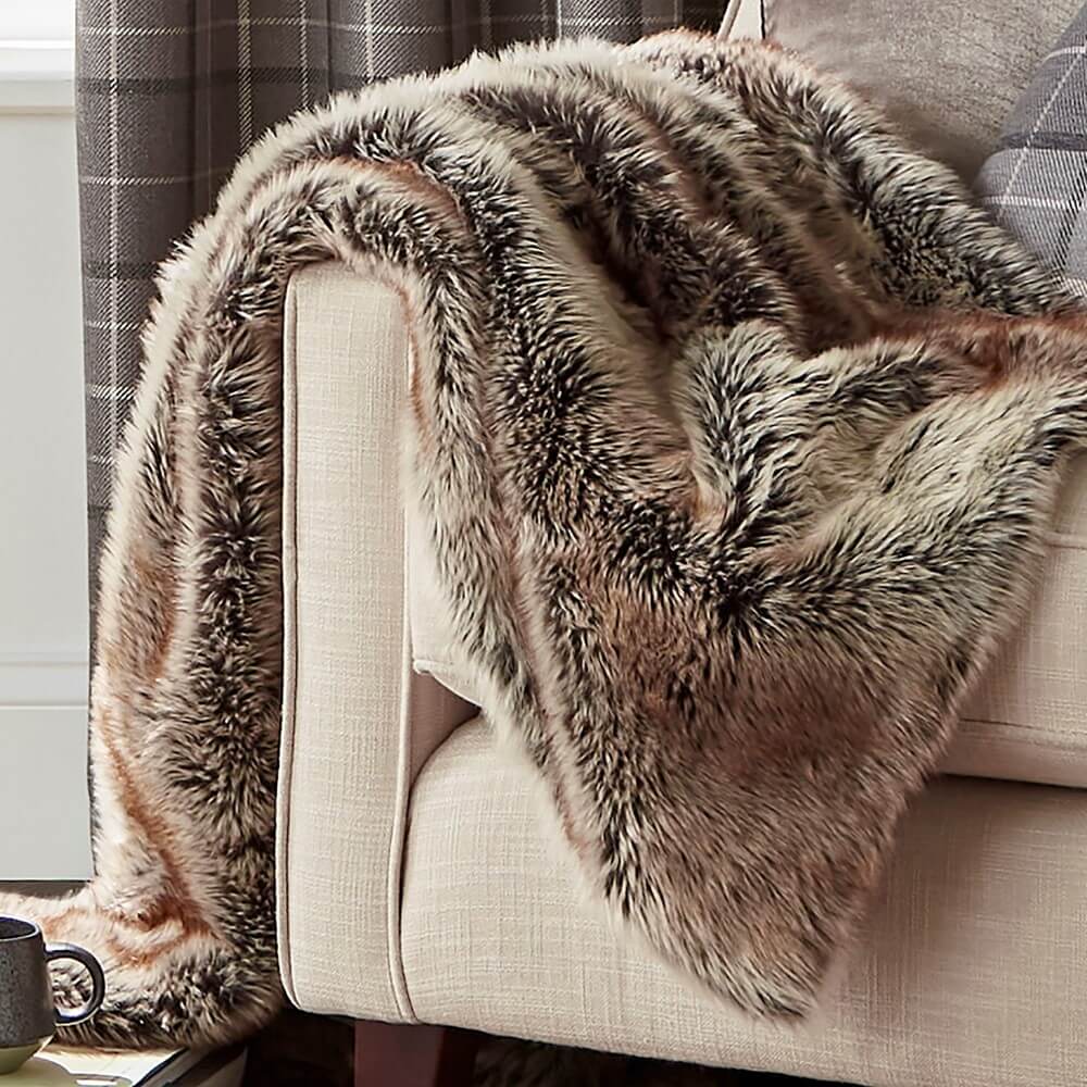 Faux fur brown throw draped over a sofa
