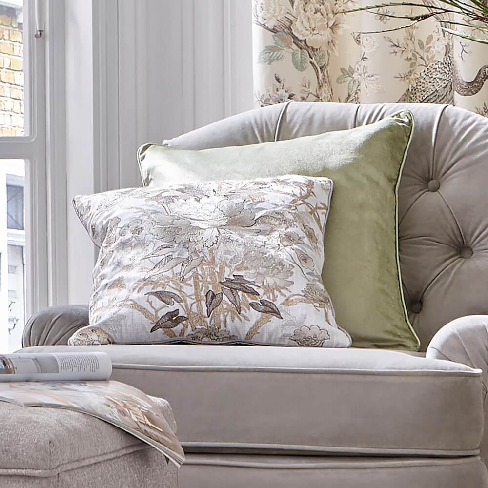 Laura ashley cushion on a grey armchair