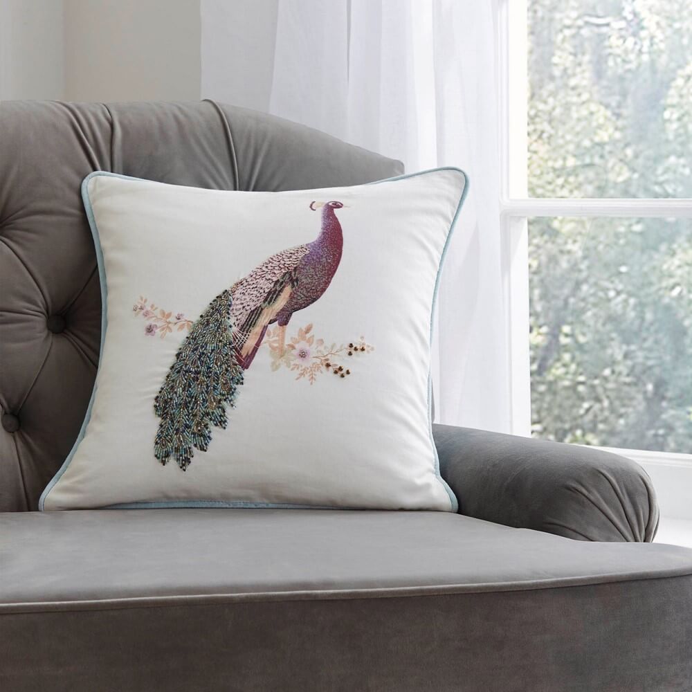 Peacock cushion on an armchair